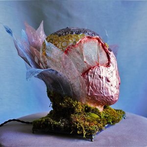 Futuristic handmade lamp Apocalypto with leaf skeletons and moss