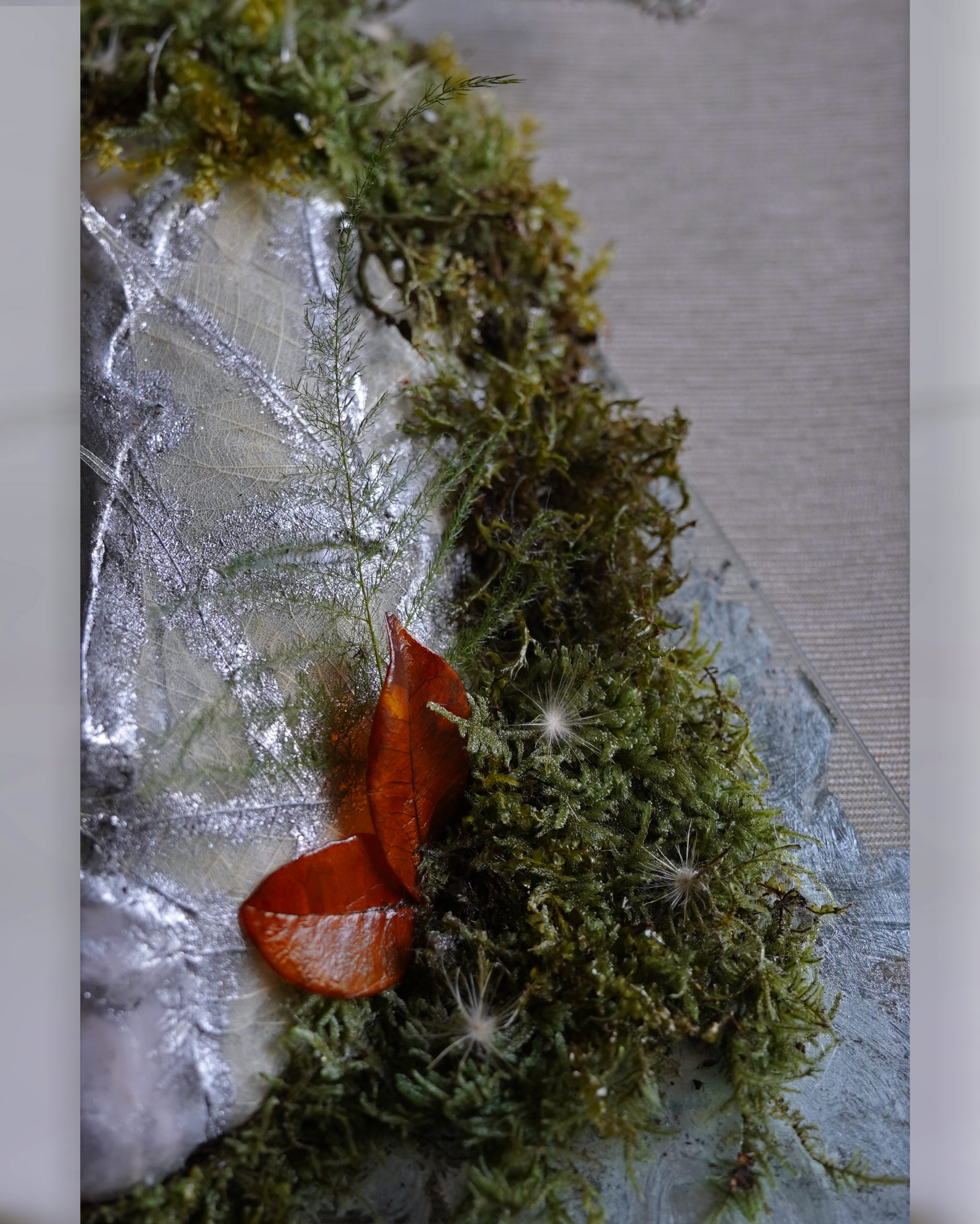 Leaf skeleton and silver texture detail on Gemini sculpture.